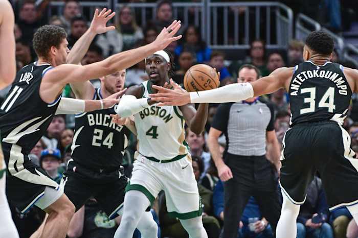 Boston Celtics guard Jrue Holiday (4) gets pressure from Milwaukee Bucks center Brook Lopez (11), guard Pat Connaughton (24) and forward Giannis Antetokounmpo (34)